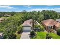 An aerial shot reveals this charming home's manicured lawn, lush landscaping, and ideal location in a tranquil neighborhood at 7439 Sea Island Ln, University Park, FL 34201