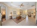 Spacious living room with tile floors, neutral paint, and tray ceiling that offers an open and airy feel at 7439 Sea Island Ln, University Park, FL 34201