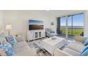 Comfortable living room with water view through sliding glass door at 850 Tidewater Shores Loop # 202, Bradenton, FL 34208