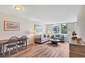 Cozy living room featuring hardwood floors, neutral paint, comfortable seating, and ocean view at 8710 Midnight Pass Rd # 202, Sarasota, FL 34242