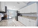 Bright kitchen with white cabinets, granite countertops, stainless steel appliances, and a breakfast nook at 6314 Bay Cedar Ln # 201, Bradenton, FL 34203