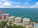 Luxury waterfront building with an ocean view on a clear, sunny day at 101 Sunset Dr # 102, Sarasota, FL 34236