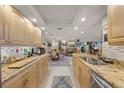 Beautiful kitchen featuring stone countertops, light-colored cabinetry, and stainless steel appliances at 101 Sunset Dr # 102, Sarasota, FL 34236