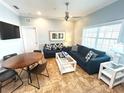 Cozy living room with comfortable sofas, round dining table, and bright natural lighting at 1020 Sun N Sea Dr # 104B, Sarasota, FL 34242