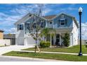 Charming two-story home boasts a three-car garage and beautifully maintained landscaping at 11702 Tetrafin Dr, Riverview, FL 33579