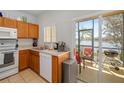 The kitchen offers a serene lake view from the sliding glass doors to the patio at 12971 Tigers Eye Dr, Venice, FL 34292