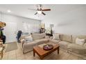 Bright living room featuring comfortable seating, tile floors and natural lighting at 12971 Tigers Eye Dr, Venice, FL 34292