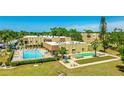 Exterior aerial view of condo building with swimming pool and shuffleboard at 1330 Glen Oaks E Dr # 374D, Sarasota, FL 34232