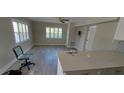 Open-concept living room with large windows and modern tile flooring at 1654 Blakemore Ln, Sarasota, FL 34231
