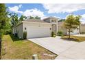 Well-maintained single-Gathering home with an attached garage, green grass, and landscaping at 1800 Little Bird Ct, Sarasota, FL 34235