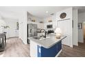 Modern kitchen with stainless steel appliances, an island, and white cabinetry at 1800 Little Bird Ct, Sarasota, FL 34235