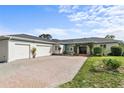 Charming single-story home featuring a three-car garage and beautiful landscaping at 1828 Mova St, Sarasota, FL 34231
