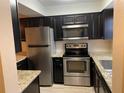 Updated kitchen featuring stainless steel appliances and granite countertops at 205 46Th Avenue W Ter # 425, Bradenton, FL 34207