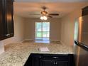 Open concept living space featuring granite countertop bar and stainless steel refrigerator at 205 46Th Avenue W Ter # 425, Bradenton, FL 34207