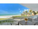 Charming balcony with seating, providing serene ocean views and coastal landscaping at 2301 Gulf Of Mexico Dr # 26N, Longboat Key, FL 34228