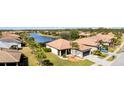 Beautiful home featuring manicured lawn, tile roof, and attractive landscaping at 2705 Taheebo Way, North Port, FL 34289