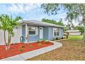 Cozy single-story home with manicured front yard, vibrant mulch and sidewalk path at 2715 52Nd Avenue W Ter, Bradenton, FL 34207
