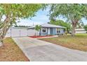 Charming single-story home with a long driveway and white fence providing curb appeal at 2715 52Nd Avenue W Ter, Bradenton, FL 34207