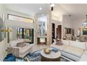 Elegant living room featuring a modern fireplace, neutral decor, and sliding glass doors that lead to an outdoor patio at 3941 Spyglass Hill Rd, Sarasota, FL 34238