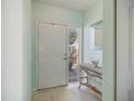 Bright foyer featuring tiled floor, light blue walls, and a decorative console table at 400 Laurel Lake Dr # 104, Venice, FL 34292