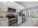 Modern kitchen with stainless steel appliances, granite countertops, and ample cabinet space at 400 Laurel Lake Dr # 104, Venice, FL 34292