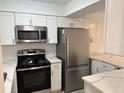 Modern kitchen featuring stainless steel appliances, white cabinets and quartz countertops at 4505 3Rd Street W Cir # 269, Bradenton, FL 34207