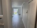 Bright living room with wood-look tile flooring and sliding glass doors to patio at 4505 3Rd Street W Cir # 269, Bradenton, FL 34207
