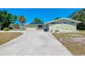 Single story home featuring an attached garage and large concrete driveway at 510 S Venice Blvd, Venice, FL 34293