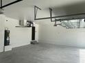 Spacious three-car garage featuring ample storage space and an installed garage door opener at 5113 Rilke Ln, Port Charlotte, FL 33981