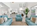 Bright, open-concept living room with high ceilings and stylish, comfortable seating, with an open connection to the kitchen at 5915 43Rd E Ct, Bradenton, FL 34203