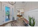 Lovely home entryway with an art-glass front door and views to the office at 6600 Horned Owl Pl, Sarasota, FL 34241