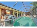 Gorgeous outdoor pool with a screened lanai, bar, and pergola at 6600 Horned Owl Pl, Sarasota, FL 34241
