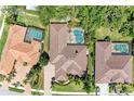 Aerial view of the property showcasing the pool, landscaping, and roof in a well-maintained neighborhood at 7913 Osprey Hammock Ct, Sarasota, FL 34240