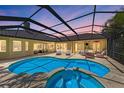 Enclosed pool and hot tub with lounge chairs offer a perfect outdoor living space, ideal for relaxation and entertainment at 7913 Osprey Hammock Ct, Sarasota, FL 34240