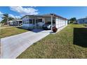 Cozy single-story home features an attached carport, a tidy lawn, and a concrete driveway, providing convenience and curb appeal at 808 53Rd E Ave # 234, Bradenton, FL 34203