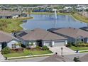 Beautiful lakefront home with a fountain view and manicured landscaping at 8722 Backshore Ln, Parrish, FL 34219