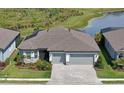 Beautiful home featuring a well-manicured front lawn and a paver driveway at 8722 Backshore Ln, Parrish, FL 34219