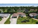 Aerial view of a home with lush landscaping, and nearby water views at 9011 Hilolo Ln, Venice, FL 34293