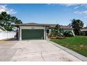 Charming home with a well-kept lawn, attached garage, and attractive landscaping at 9011 Hilolo Ln, Venice, FL 34293