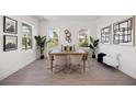 Elegant dining room with bright light, wood floors, and stylish decor at 9035 Duany Ln, Lakewood Ranch, FL 34240