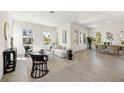Bright and airy living room featuring modern decor, wood floors, and lots of natural light at 9035 Duany Ln, Lakewood Ranch, FL 34240