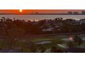 Sunset aerial view showcasing the golf course, coastline, and city skyline at 1050 Longboat Club Road # 903, Longboat Key, FL 34228