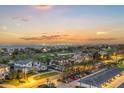 Beautiful coastal view of the neighborhood with lush green lawns, neighborhood parking, and a stunning sunset at 1050 Longboat Club Road # 903, Longboat Key, FL 34228
