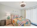 Bright bedroom with a colorful quilt, modern ceiling fan, and nautical artwork creates a soothing retreat at 117 7Th N St # 5, Bradenton Beach, FL 34217