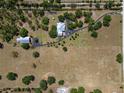 Overhead view of expansive land featuring a home with an outbuilding, with trees scattered on the property at 12615 River Rd, Myakka City, FL 34251