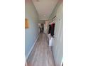 Inviting foyer features wood-look tile flooring, a coat rack with bench, and a view into the kitchen at 1609 17Th W St, Bradenton, FL 34205