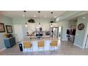 Bright kitchen with granite countertops, modern stainless steel appliances, and a functional island with bar seating at 1609 17Th W St, Bradenton, FL 34205