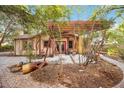Secluded backyard with stone patio, wooden pergola, and lush landscaping at 1721 8Th Street, Sarasota, FL 34236