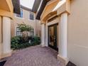 Charming entryway with brick pavers and elegant white columns at 23572 Awabuki Dr # 202, Venice, FL 34293