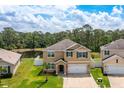 Two-story home featuring a well-manicured lawn and pond view at 259 Tierra Verde Way, Bradenton, FL 34212